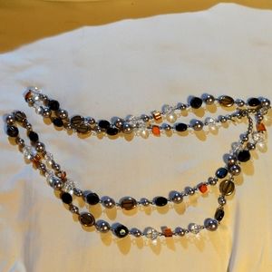 Long, layered modern beaded and metallic necklace